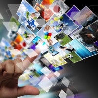 close up of hand streaming images as internet concept