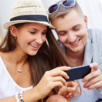 Millennials using mobile phone outside